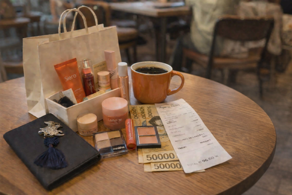 Travel flat lay in Korea with passport, wallet, Korean won cash, and coffee on a cafe table in Seoul